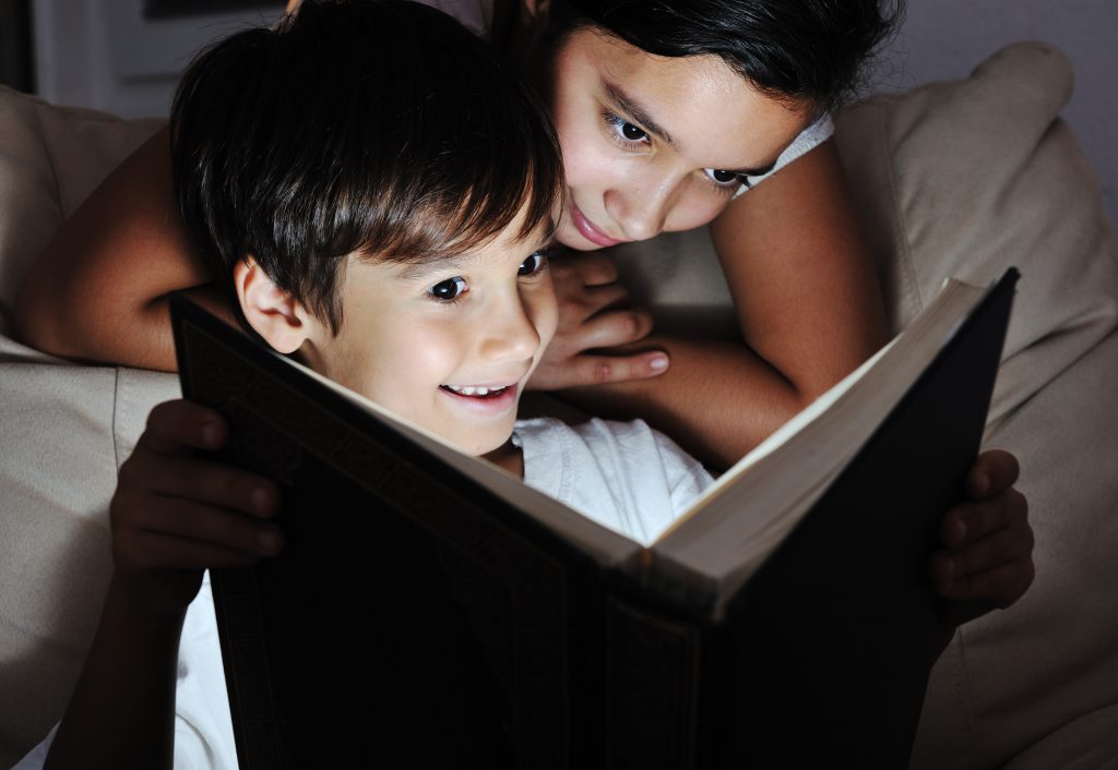 Boy and Girl reading book.
